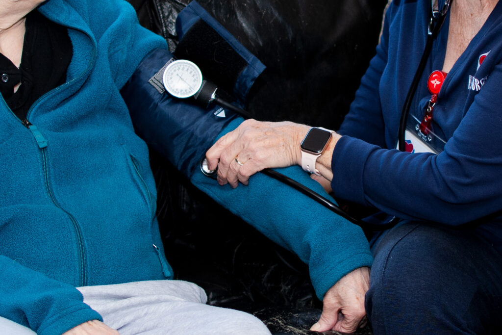 A VNA nurse checking a patient's vitals.