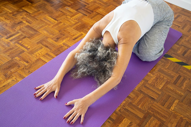 senior woman practicing yoga for web