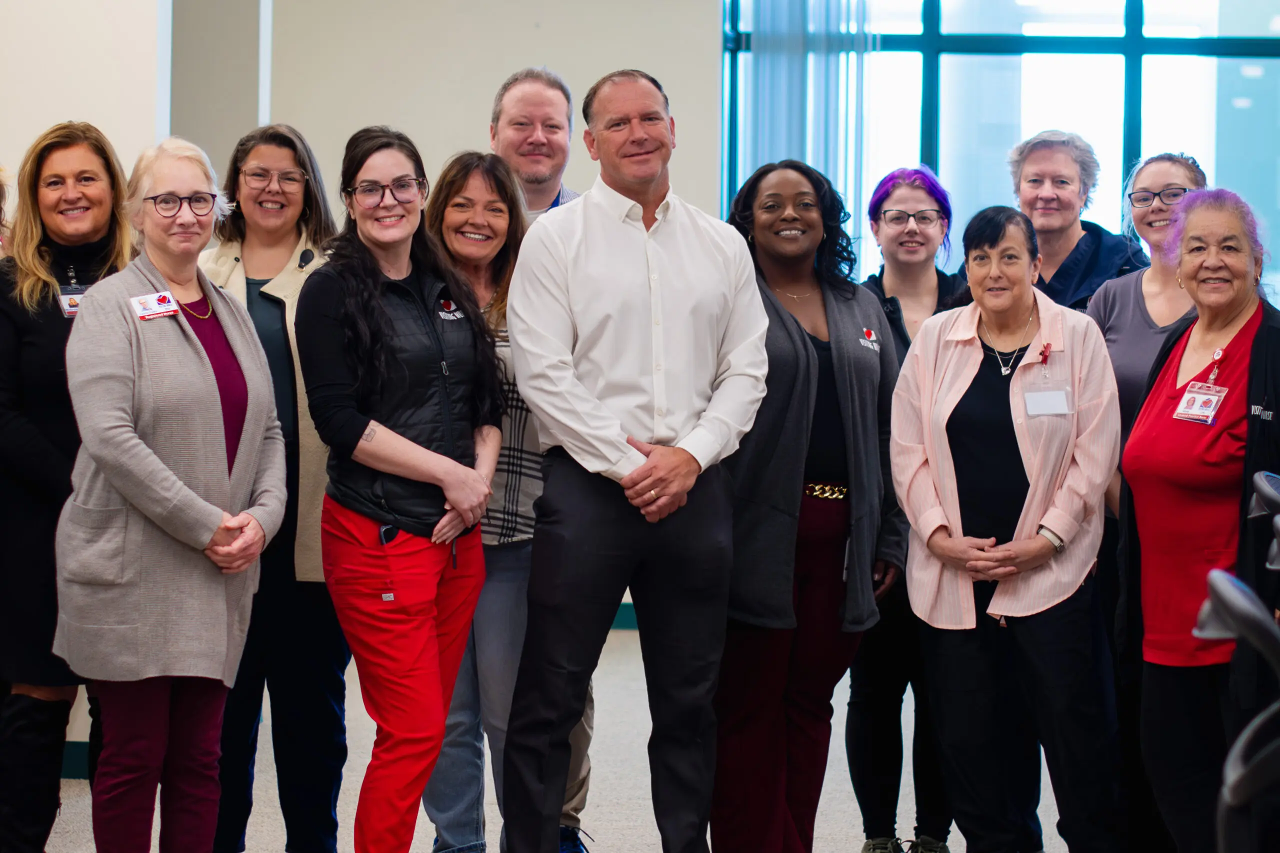 VNA's Medical Director, Mark A. Wiles, MD, Stands with members of the Hospice team and other VNA staff.